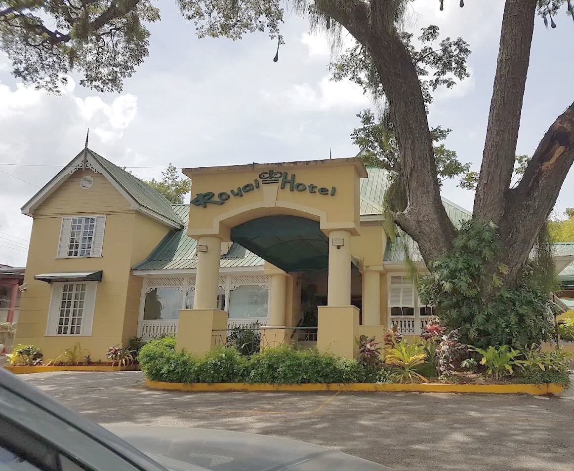 The Royal Hotel entrance gate under a large samaan tree